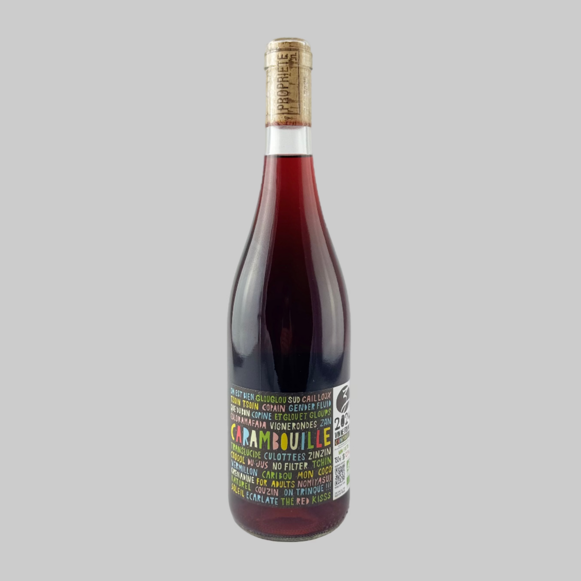 Wine bottle with a colourful label on a grey background