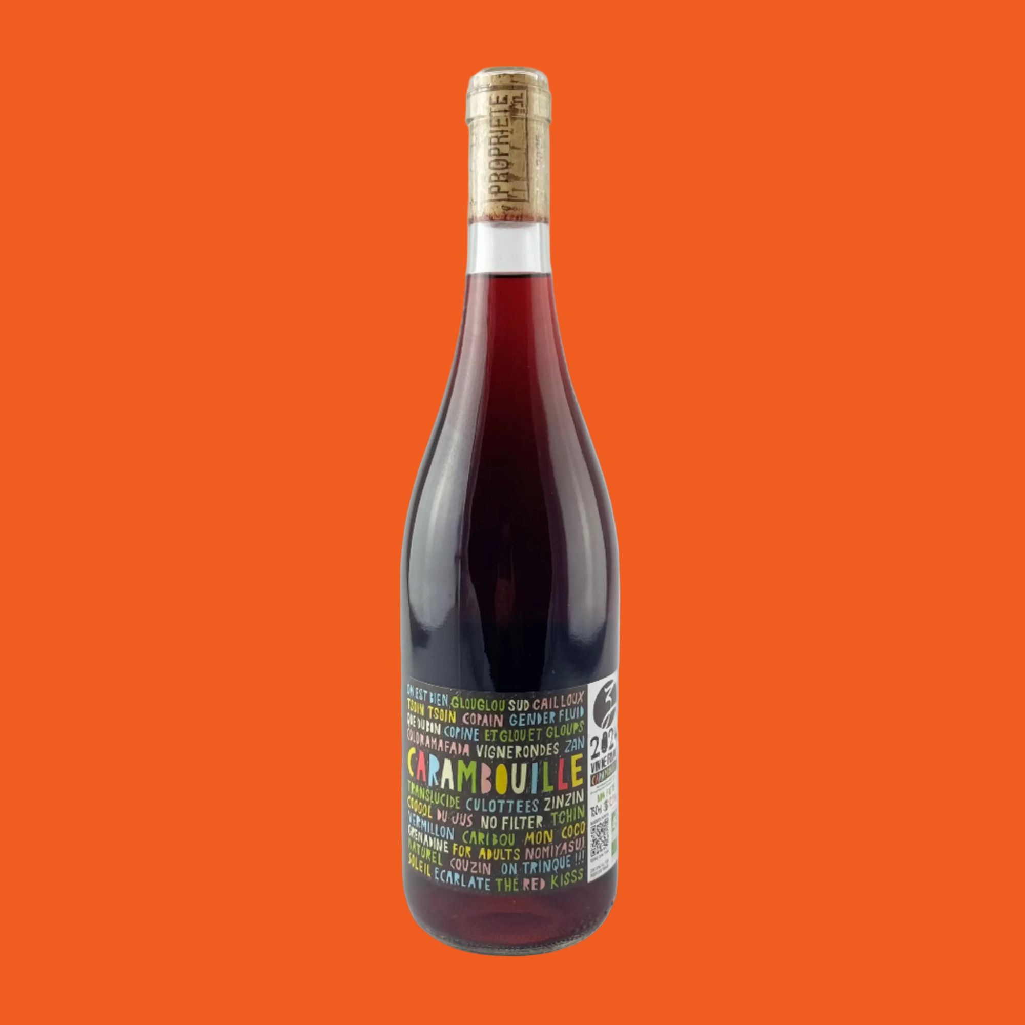 Wine bottle of Carambouille 2024 with a colourful label on a orange background