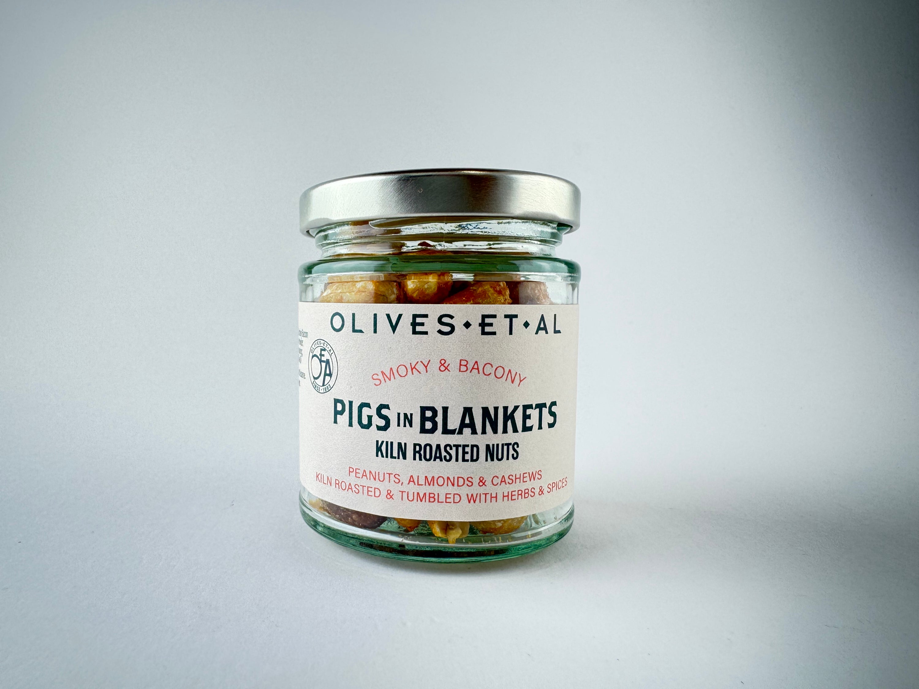 Packet of Pigs in Blanket Kiln Roasted Nuts on a grey background