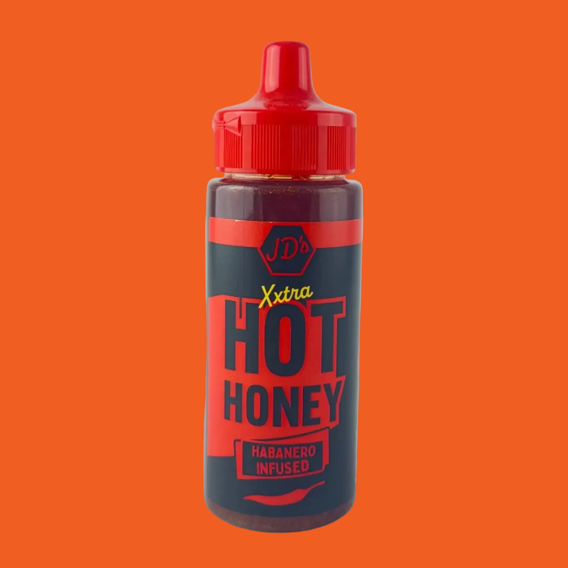 Bottle of J.D.'s Xtra Hot Honey with red cap on orange background

