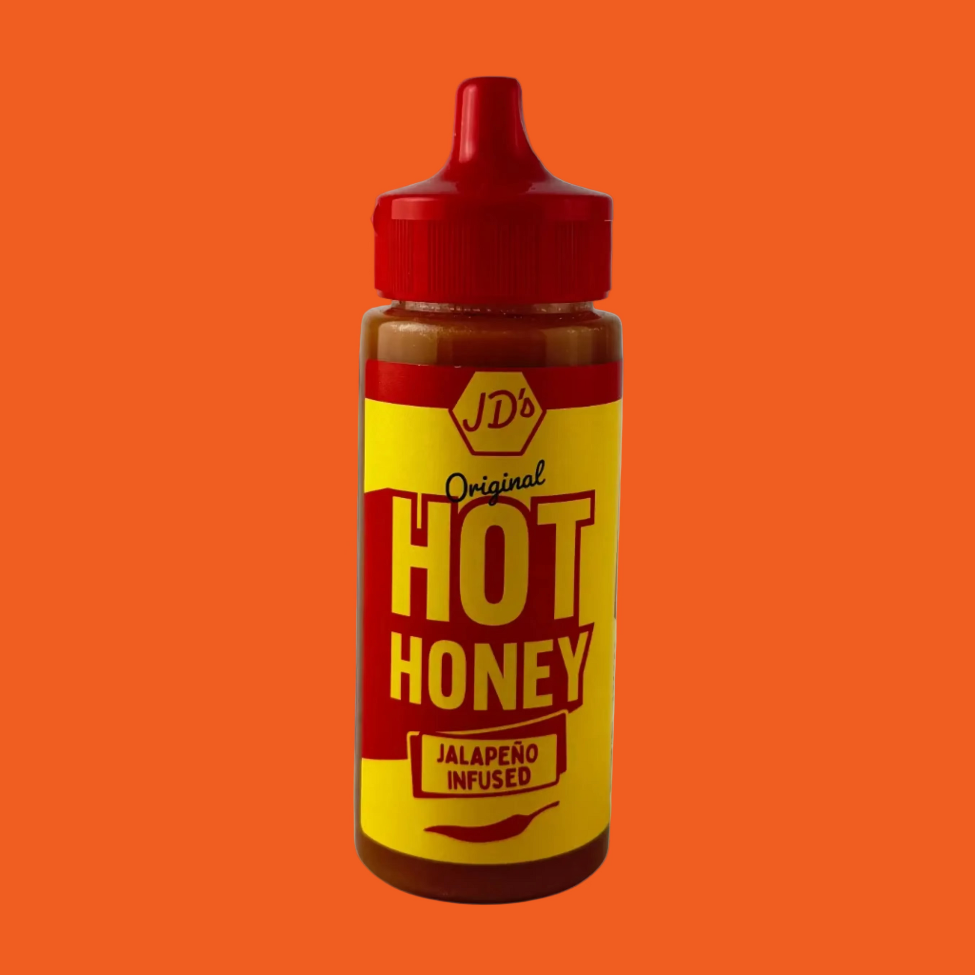 Bottle of J.D.'s Hot Honey with a red cap on a orange background