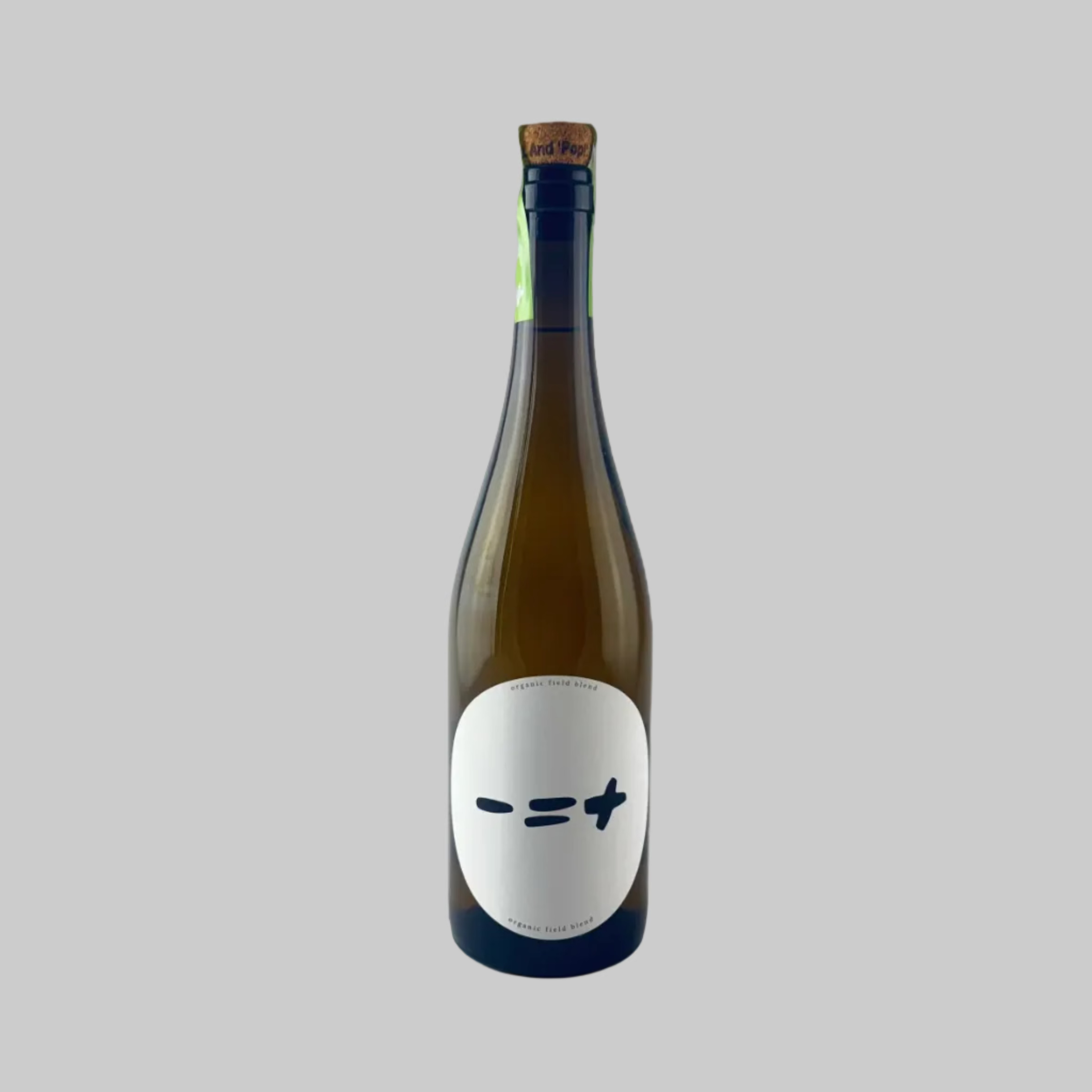 Bottle of Less is More Organic Field Blend wine with a white minimalist label on a grey background