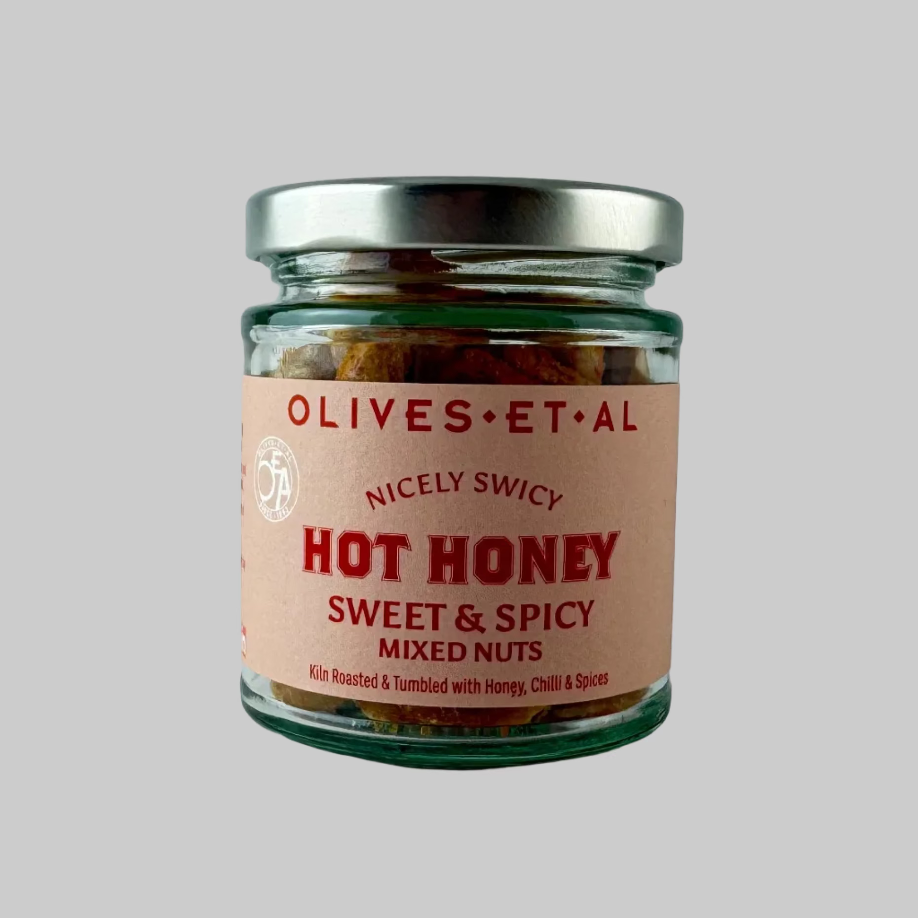 Jar of 'Hot Honey Sweet & Spicy Mixed Nuts' by Olives Et Al on a grey background