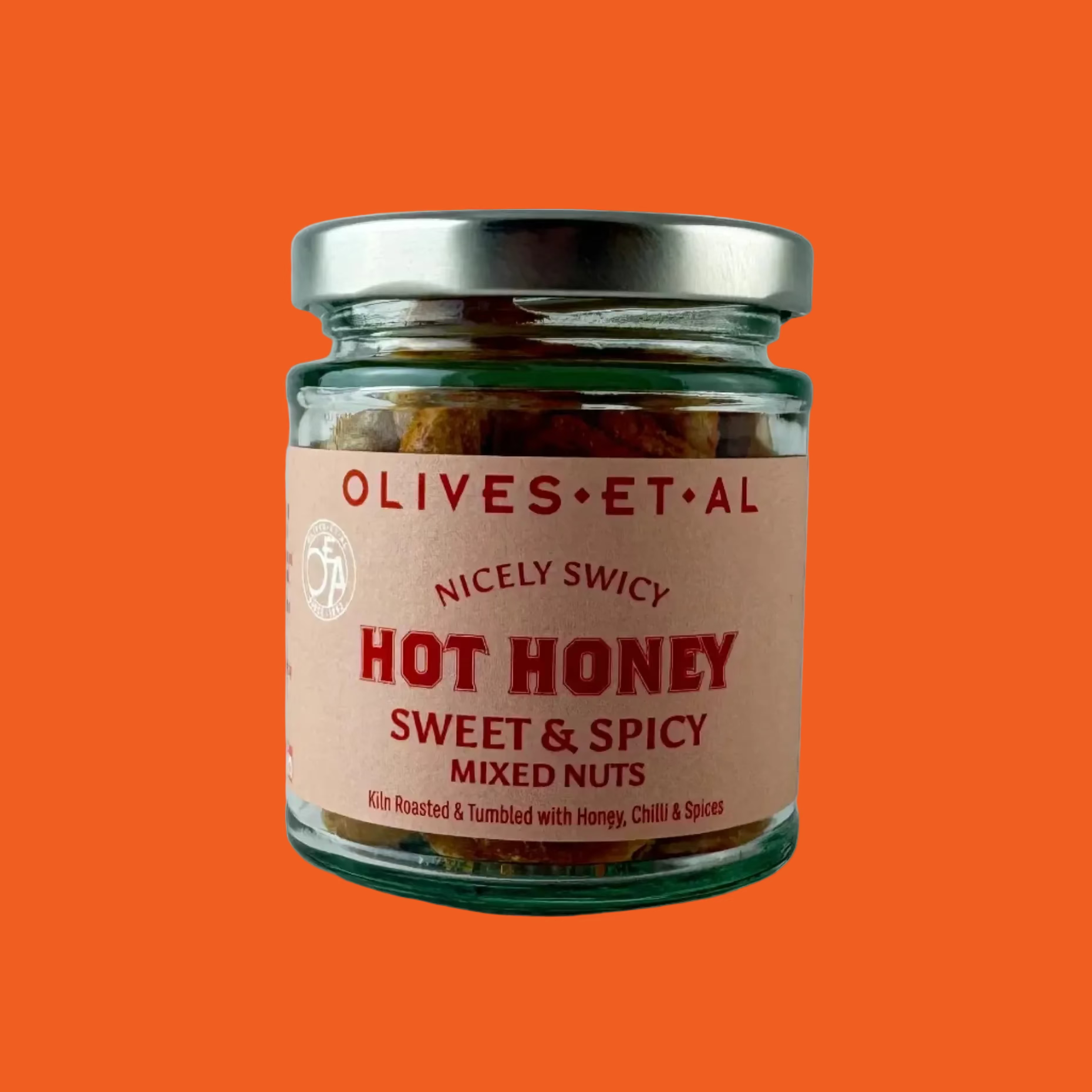 Jar of 'Hot Honey Sweet & Spicy Mixed Nuts' by Olives et al on a orange background

