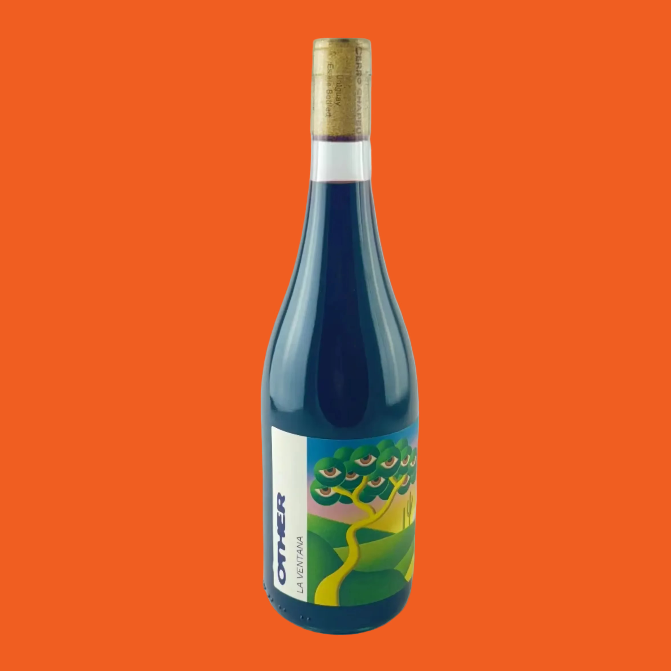 Blue wine bottle with a colourful label on a orange background