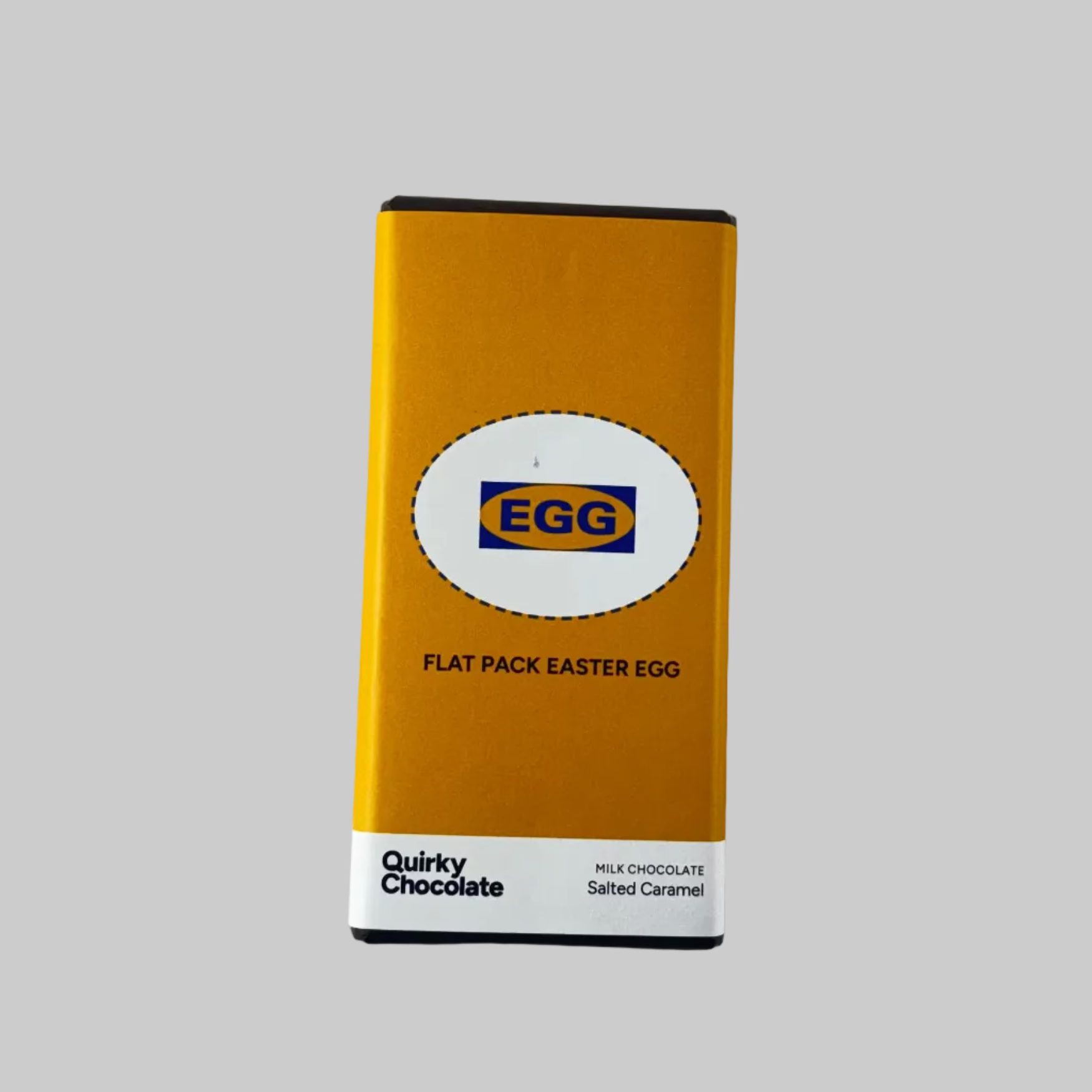 Bar of Quirky Chocolate Flat Pack Easter Egg chocolate bar with a yellow packaging on grey background